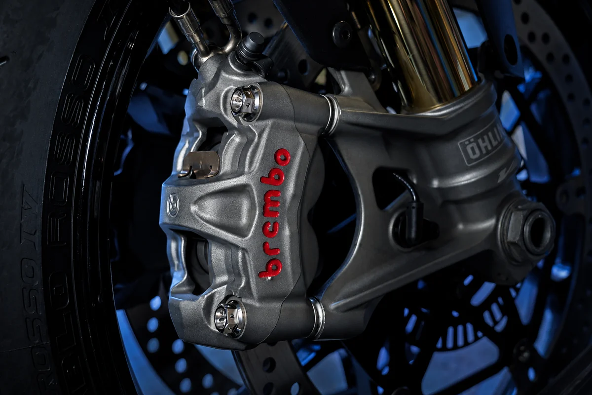Darkened Brembo motorcycle caliper with titanium bolts